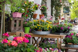 Close-up of a charming market stall overflowing with fresh flowers and local crafts.