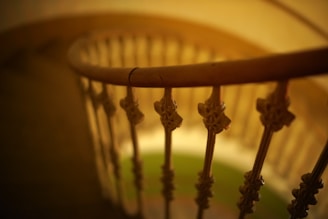 Close-up of textured copper accents on a staircase railing, highlighting craftsmanship and warmth.