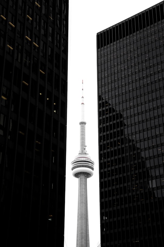 CN tower in between glass skyscrapers in CN Tower Canada