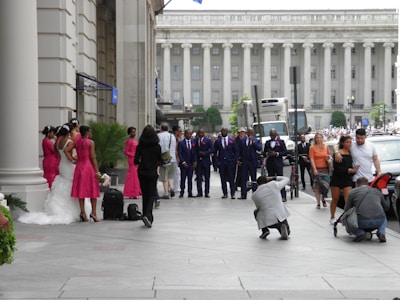 A diverse group of brides and grooms smiling and chatting at a community event.