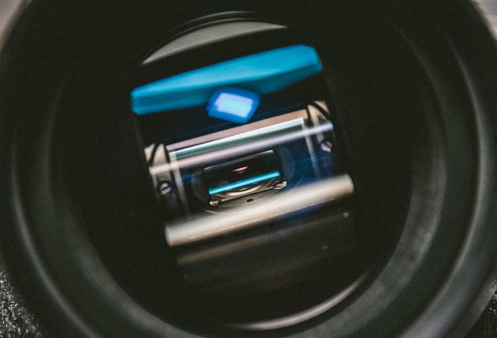 a close up of a camera lens with a cell phone in it