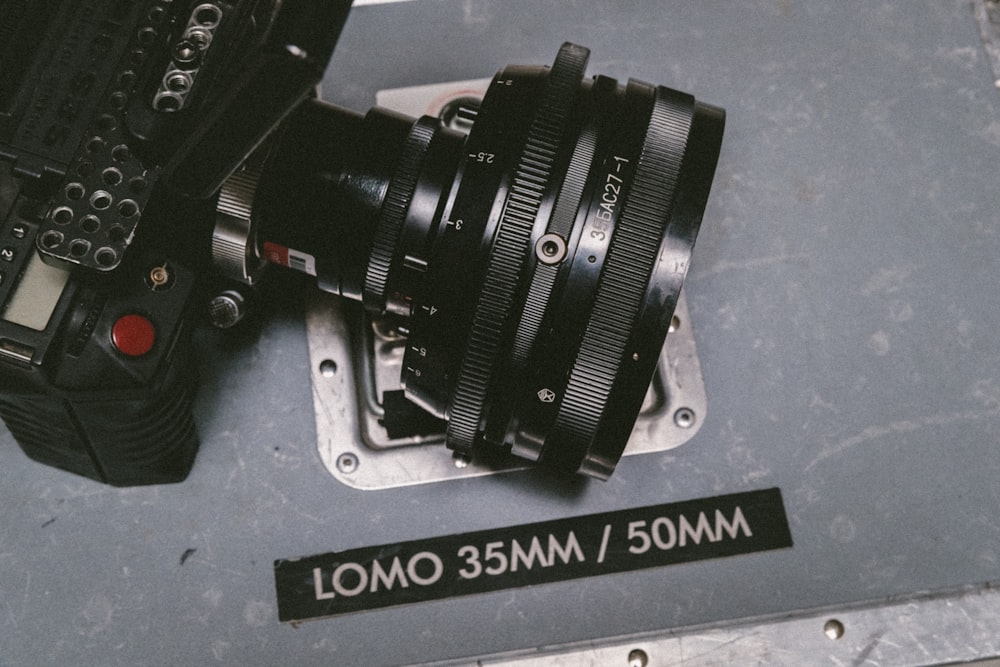 black Lomo DSLR camera on gray floor surface