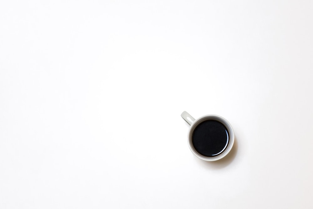 top view photography of mug with black liquid