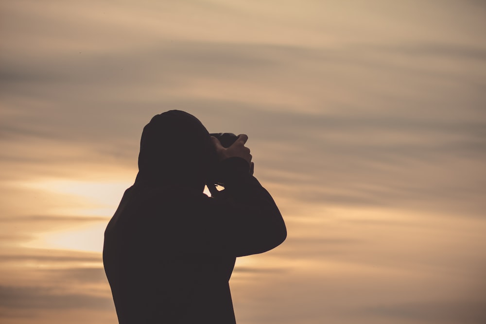 person using camera fronting the sky