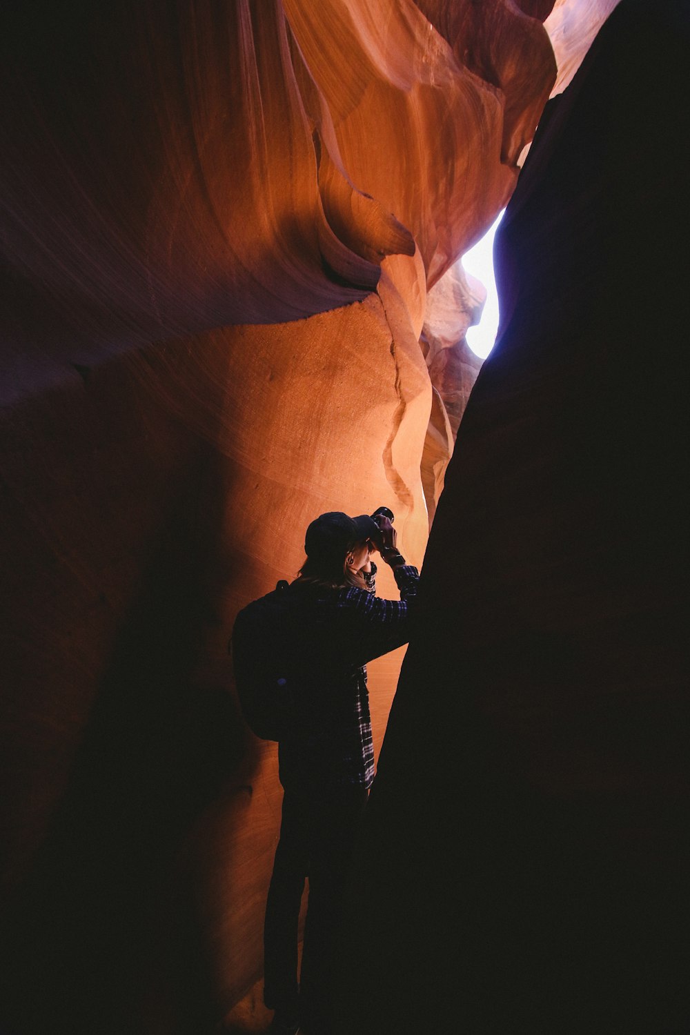 man standing inside cave