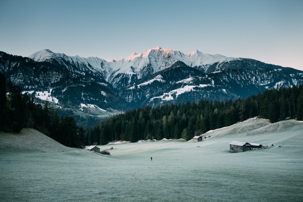 house on snow field beside mountain