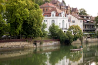 A serene riverside view near Vernier with a small boat and lush greenery.