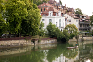 A serene riverside view near Vernier with a small boat and lush greenery.
