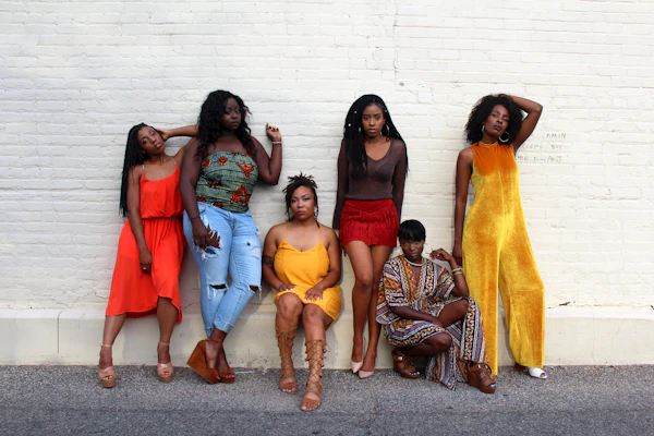 Diverse group of women smiling confidently wearing different styles of menstrual underwear in natural light.