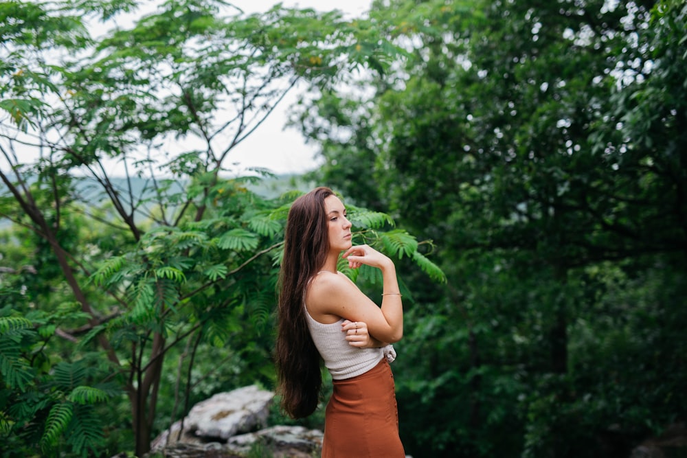 woman taking photo near trees