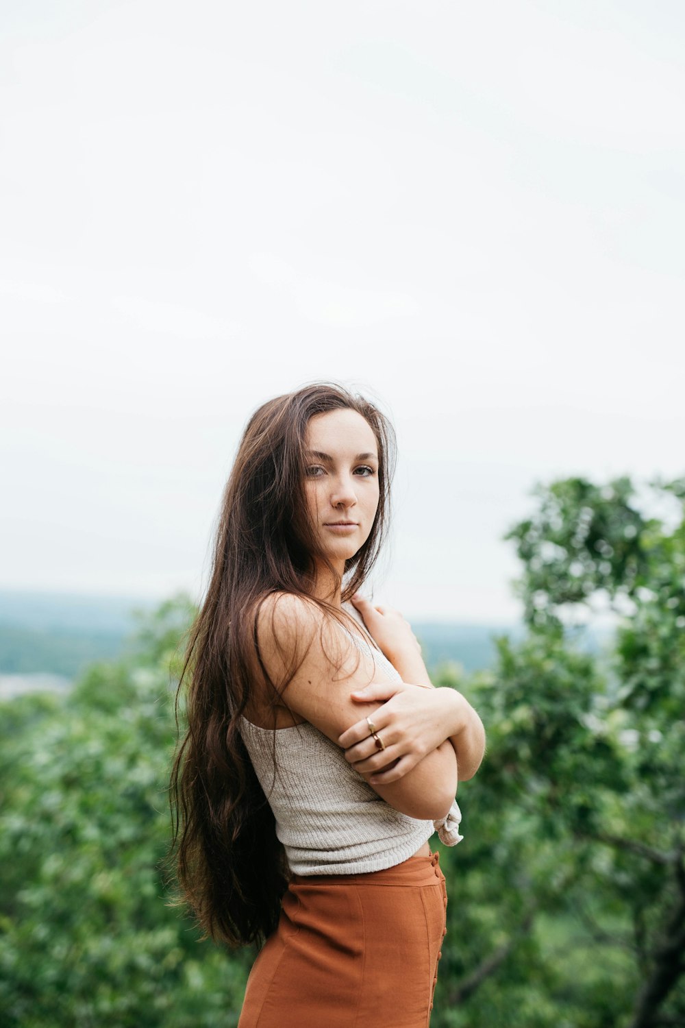 woman wearing white knitted top and brown bottoms