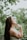 A woman reflecting peacefully in a serene outdoor setting.