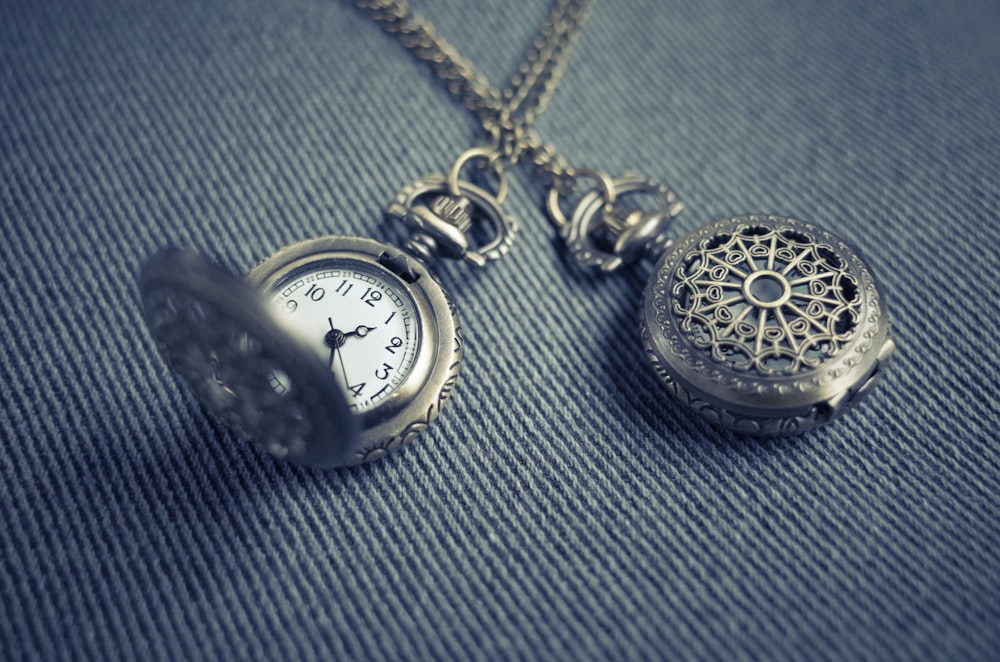 silver-colored stopwatch pendant