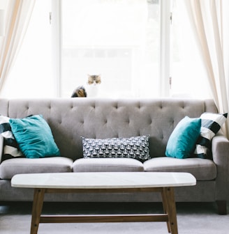 brown and white wooden table beside sofa chair