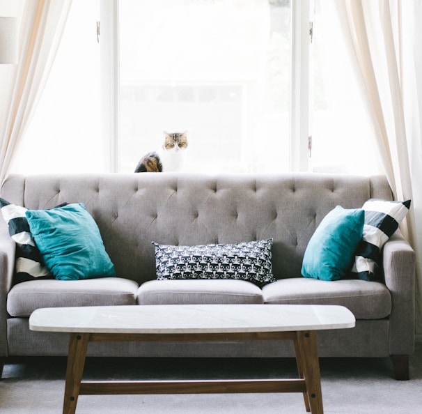 brown and white wooden table beside sofa chair