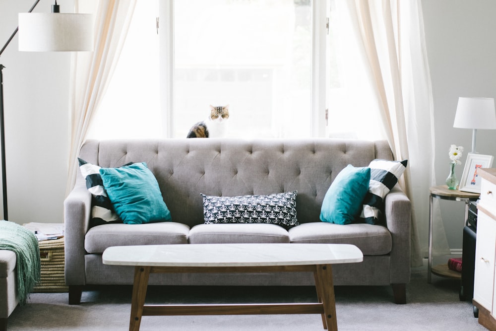 brown and white wooden table beside sofa chair