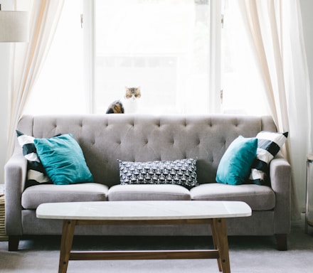 brown and white wooden table beside sofa chair