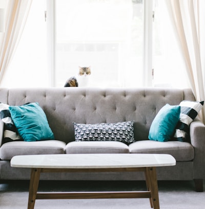 brown and white wooden table beside sofa chair