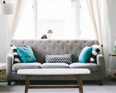 brown and white wooden table beside sofa chair