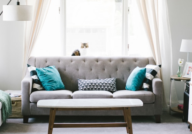 brown and white wooden table beside sofa chair