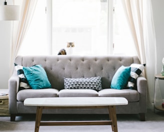 brown and white wooden table beside sofa chair