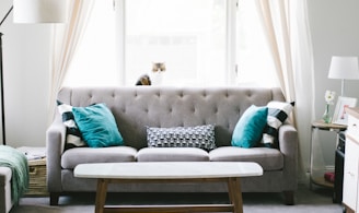 brown and white wooden table beside sofa chair