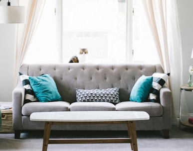 brown and white wooden table beside sofa chair