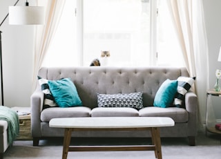 brown and white wooden table beside sofa chair