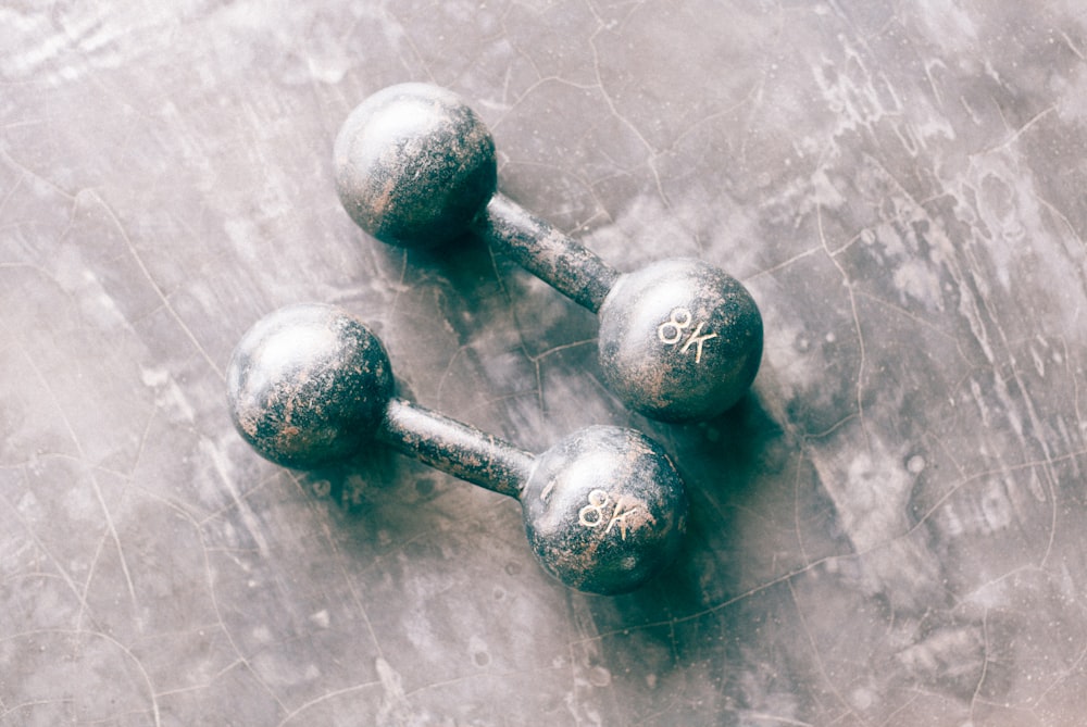 two gray dumbbells