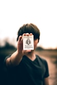 selective focus photography of person holding ace of spades card