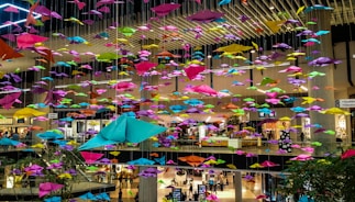 Close-up of hands distributing colorful promotional flyers in a busy store