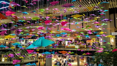 Close-up of hands distributing colorful promotional flyers in a busy store