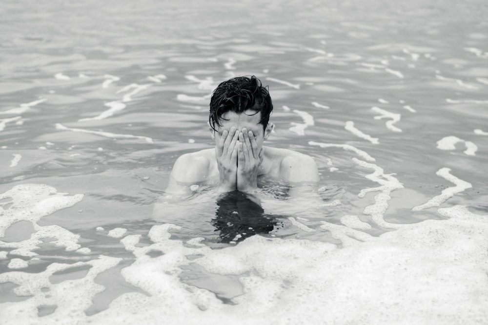 grayscale photo of man on body of water