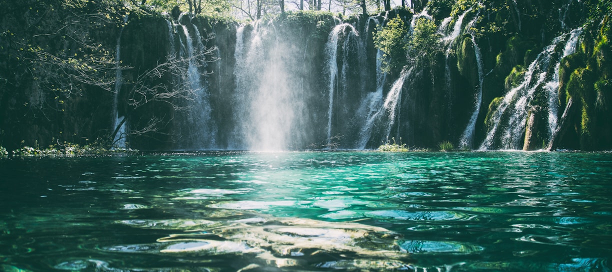 time-lapse photography of flowing multi-tier waterfall