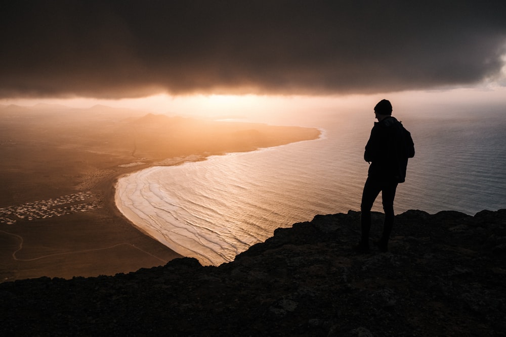 silhouette of person looking at the horizon