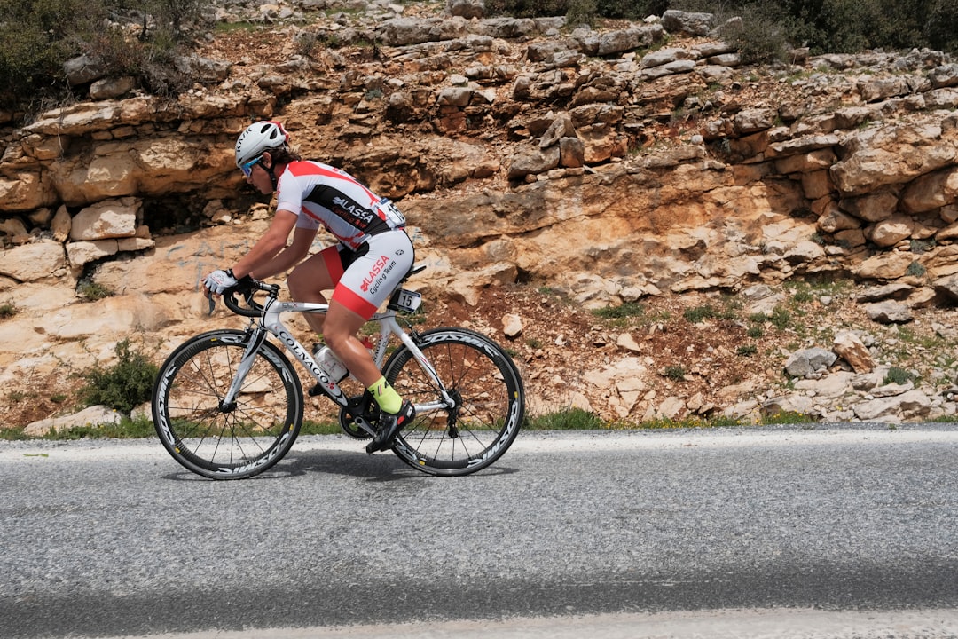 man riding road bike during day