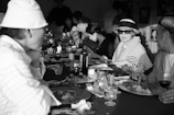 A small group of guests sharing stories and laughter around an intimate supper table.