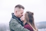 man kissing woman