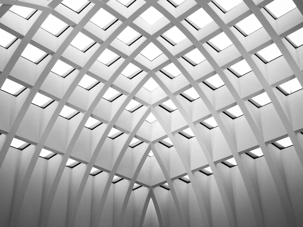 the ceiling of a building with many square windows