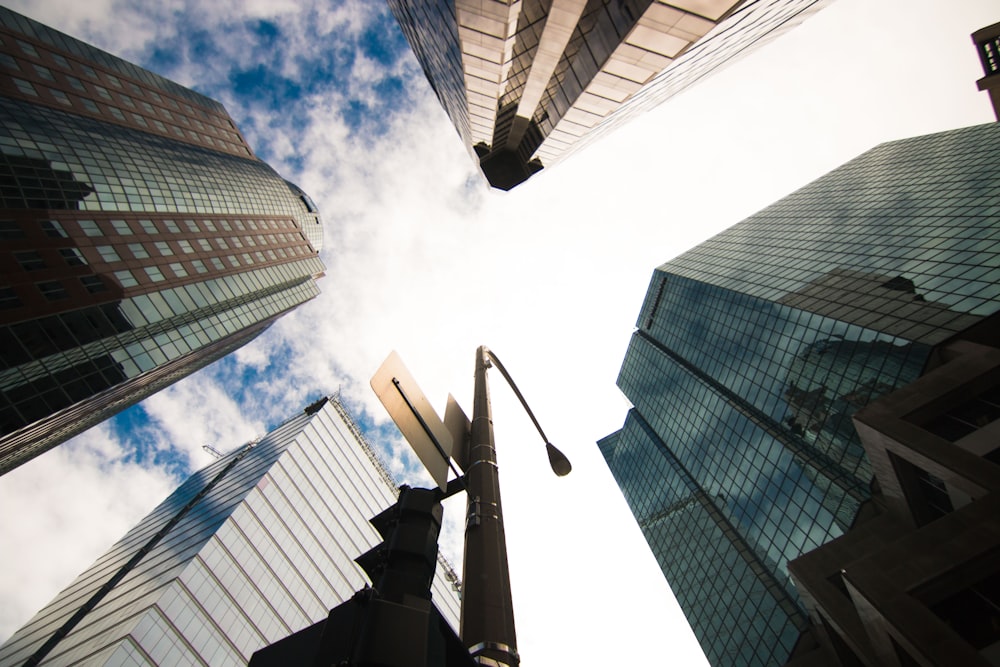 worm view photo of buildings under cloudy sky