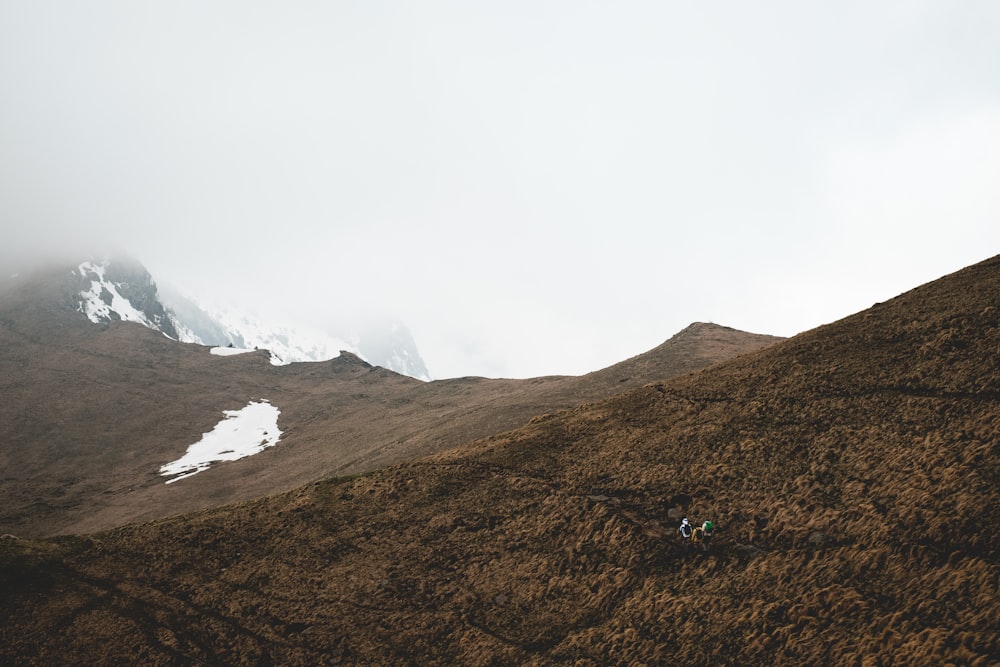 soil covered hills during day