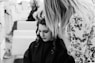 grayscale photography of woman getting her hair done inside salon