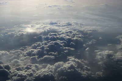 An artistic close-up of soft, fluffy clouds with sunlight streaming through, evoking wonder and curiosity.