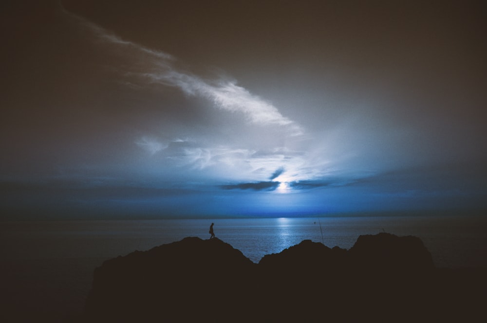 silhouette of rock island during sunrise