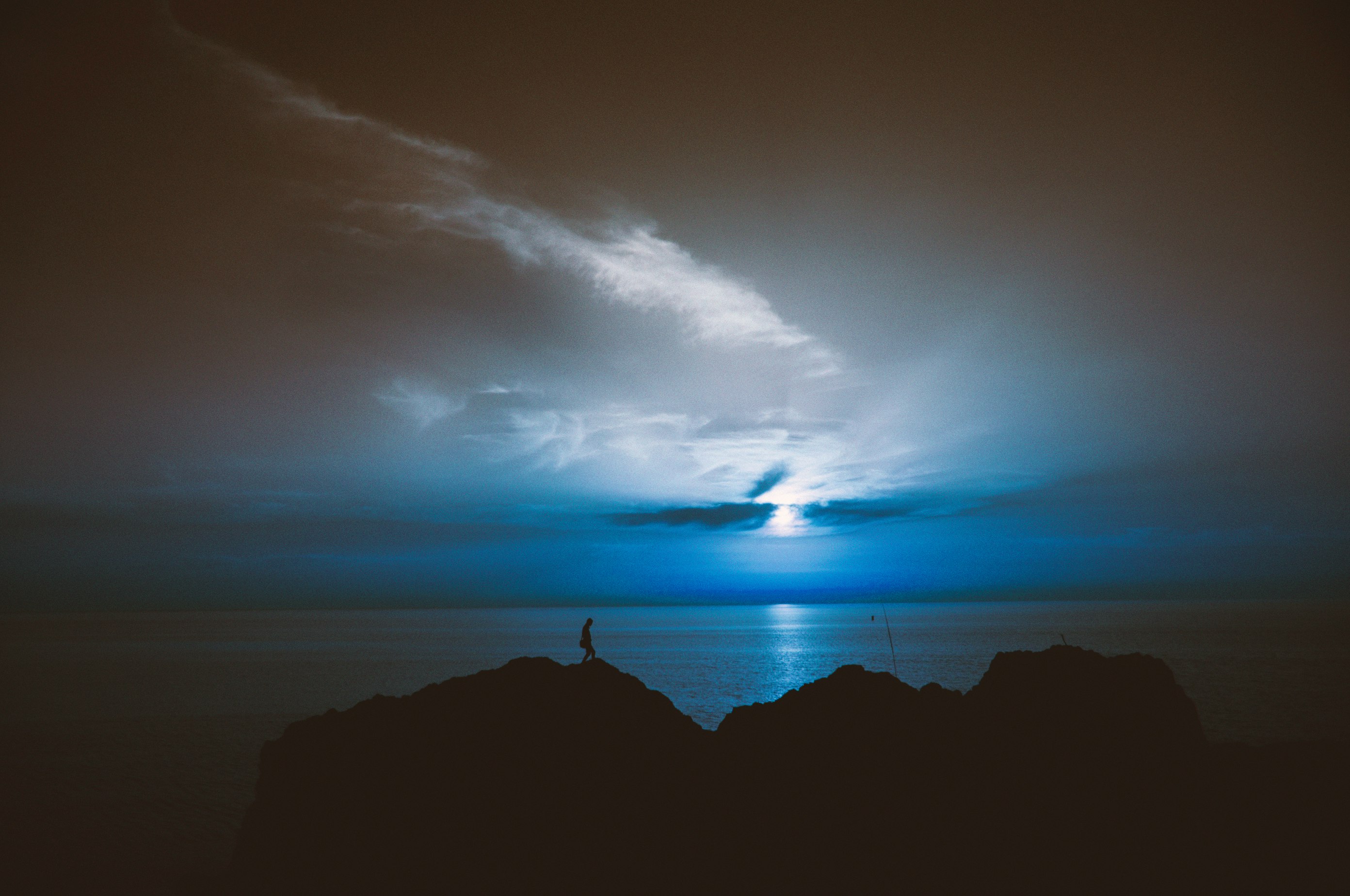 silhouette of rock island during sunrise