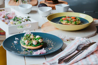 Close-up photo of Scandinavian-style dishes artfully plated in a modern restaurant setting.