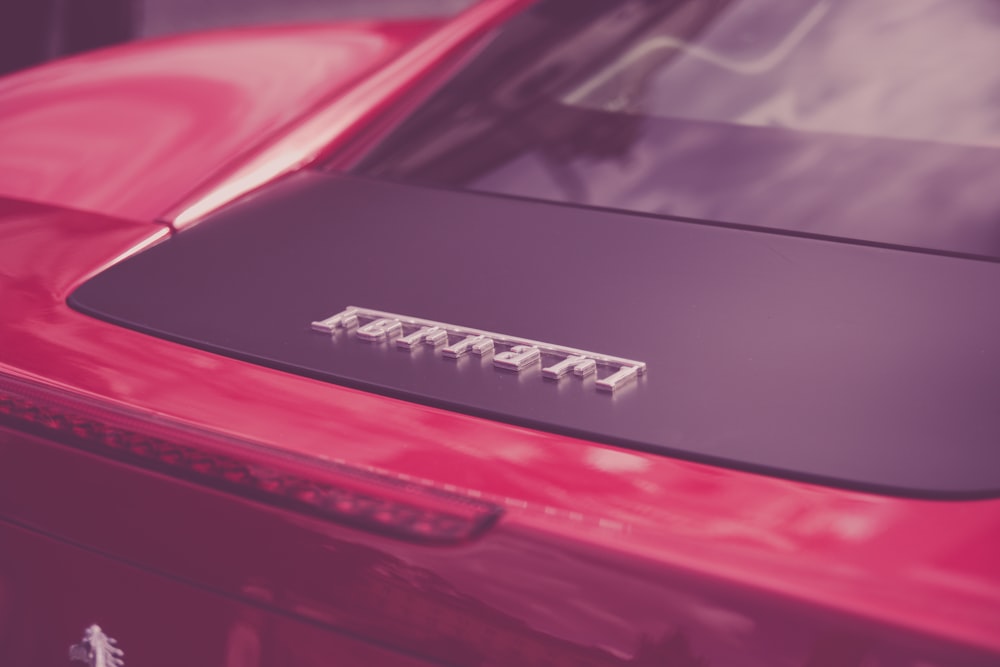 a close up of the hood of a red car