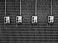 four black-and-grey telephones