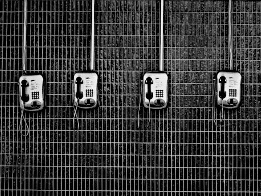 four black-and-grey telephones