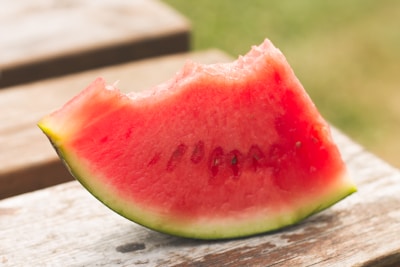 Slices of vibrant red watermelon resting on green grass